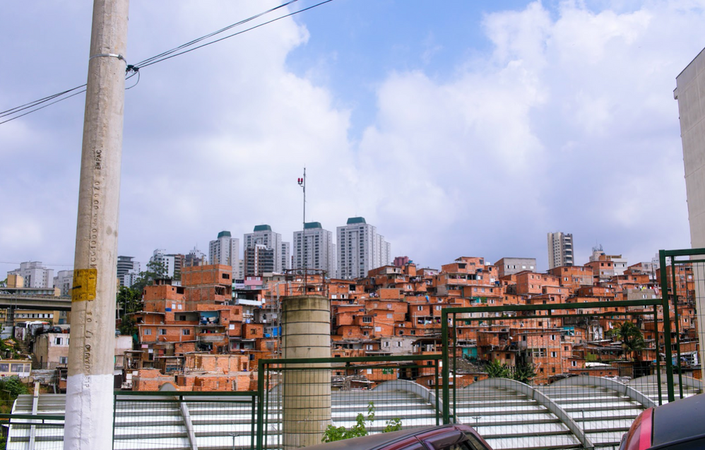 Morumbi & Paraisópolis, by Camille Ward, 2018 https://afsee.atlanticfellows.org/blog/johnny-miller-paraisopolis-brazil-tuca-vieira This photo is meant to draw attention to the fact that the racial wealth gap persists in many societies. In São Paulo, Brazil, I came across a striking example of inequality on my walk in the favela with large luxury apartments towering  in the distance in the adjacent neighborhood, Morumbi.